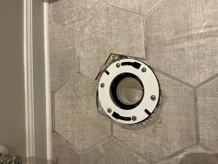 New toilet flange set into hexagon tile flooring in Pittsburgh, PA
