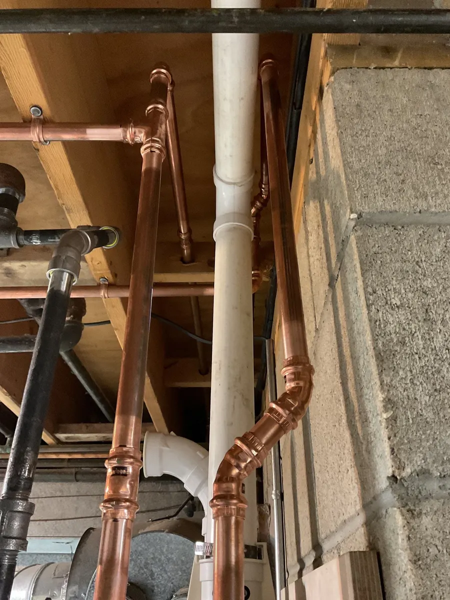New copper water lines run through basement joists in Pittsburgh, PA