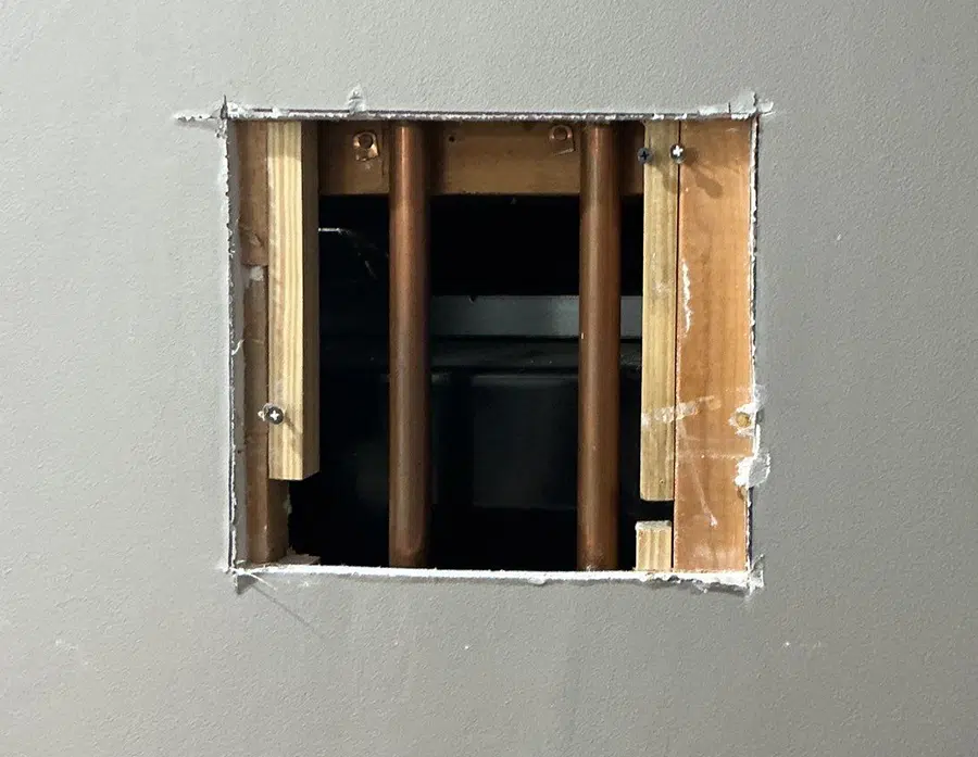 Wall access cut exposing copper water lines in Pittsburgh, PA