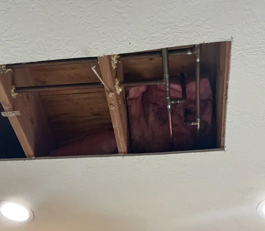 Ceiling access exposing galvanized pipe and insulation in Pittsburgh, PA