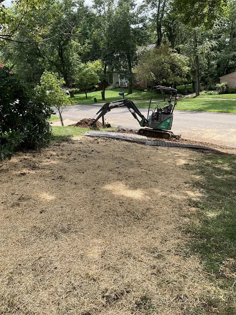 Mini excavator digging for a water line replacement in Pittsburgh, PA