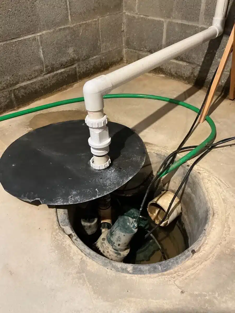 sump pump system installed in a basement pit