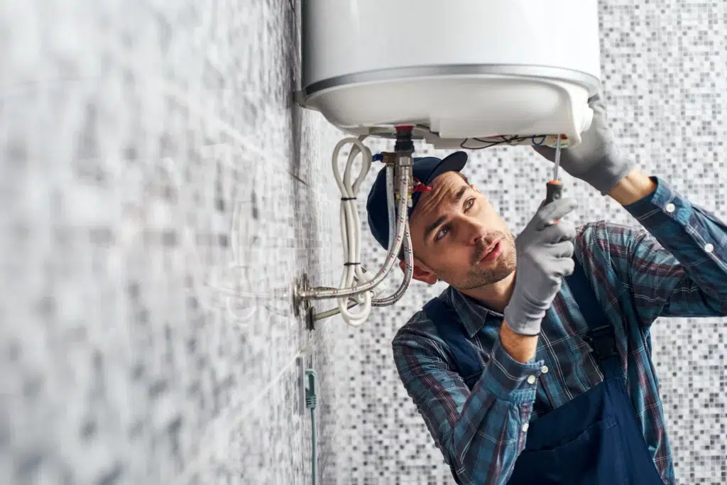 Technician working on water heater in Pittsburgh, PA.