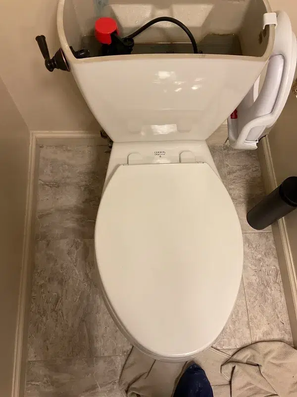 Toilet tank repair during professional plumbing service in a Pittsburgh area home.