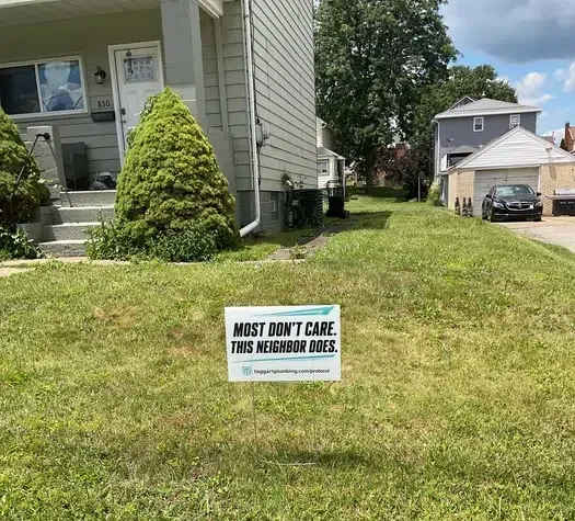 Taggart Plumbing yard sign staked in a residential front lawn following a completed service call in Monaca, PA