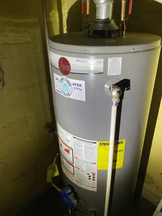 Rheem gas water heater installed in a residential basement by the Taggart Plumbing team in Pittsburgh, PA