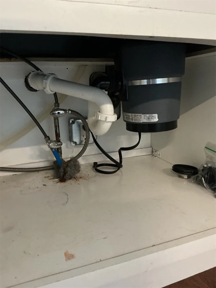 New garbage disposal installed under a sink cabinet in Pittsburgh, PA