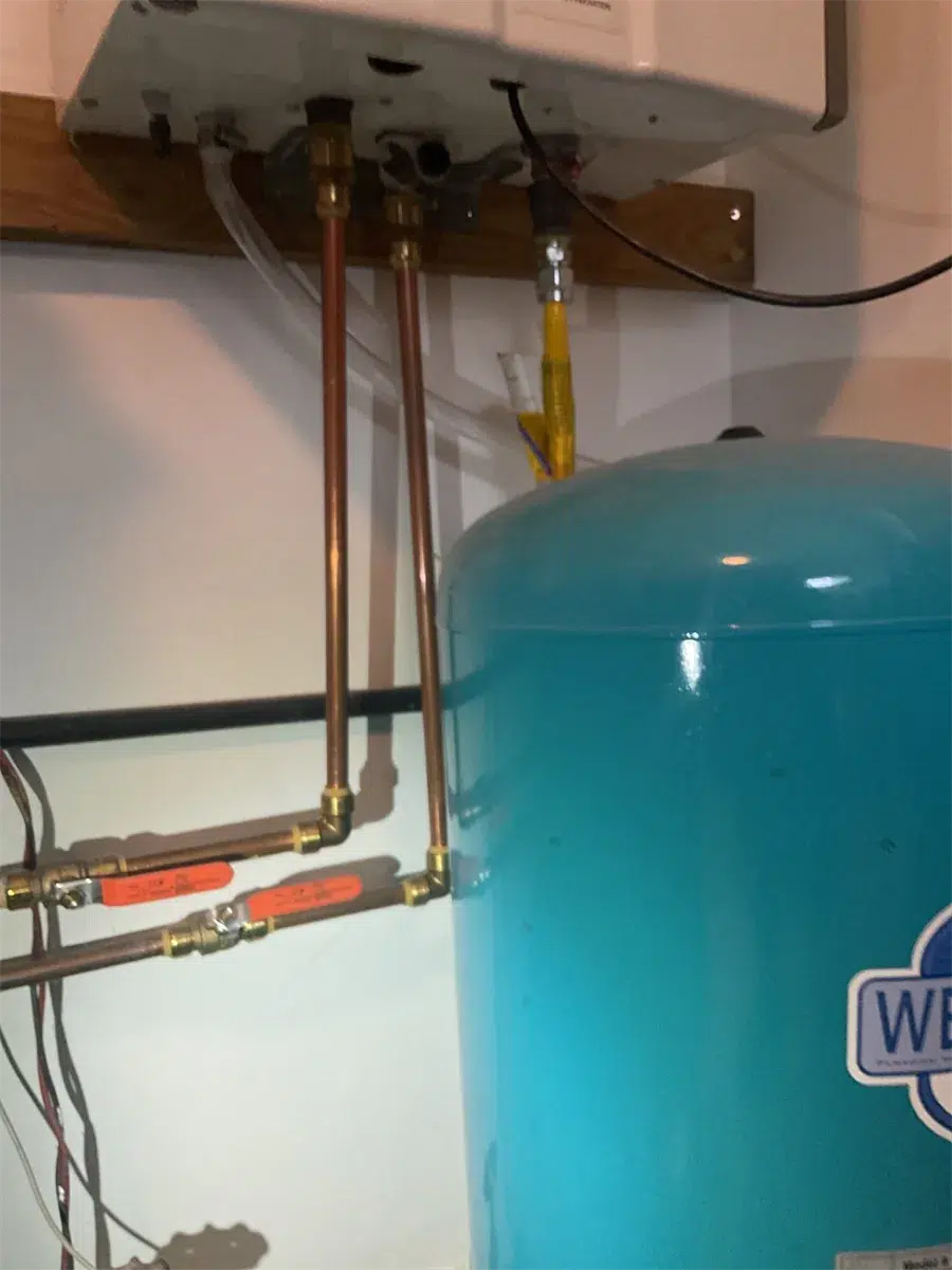 Copper piping and expansion tank below a tankless water heater in Pittsburgh, PA