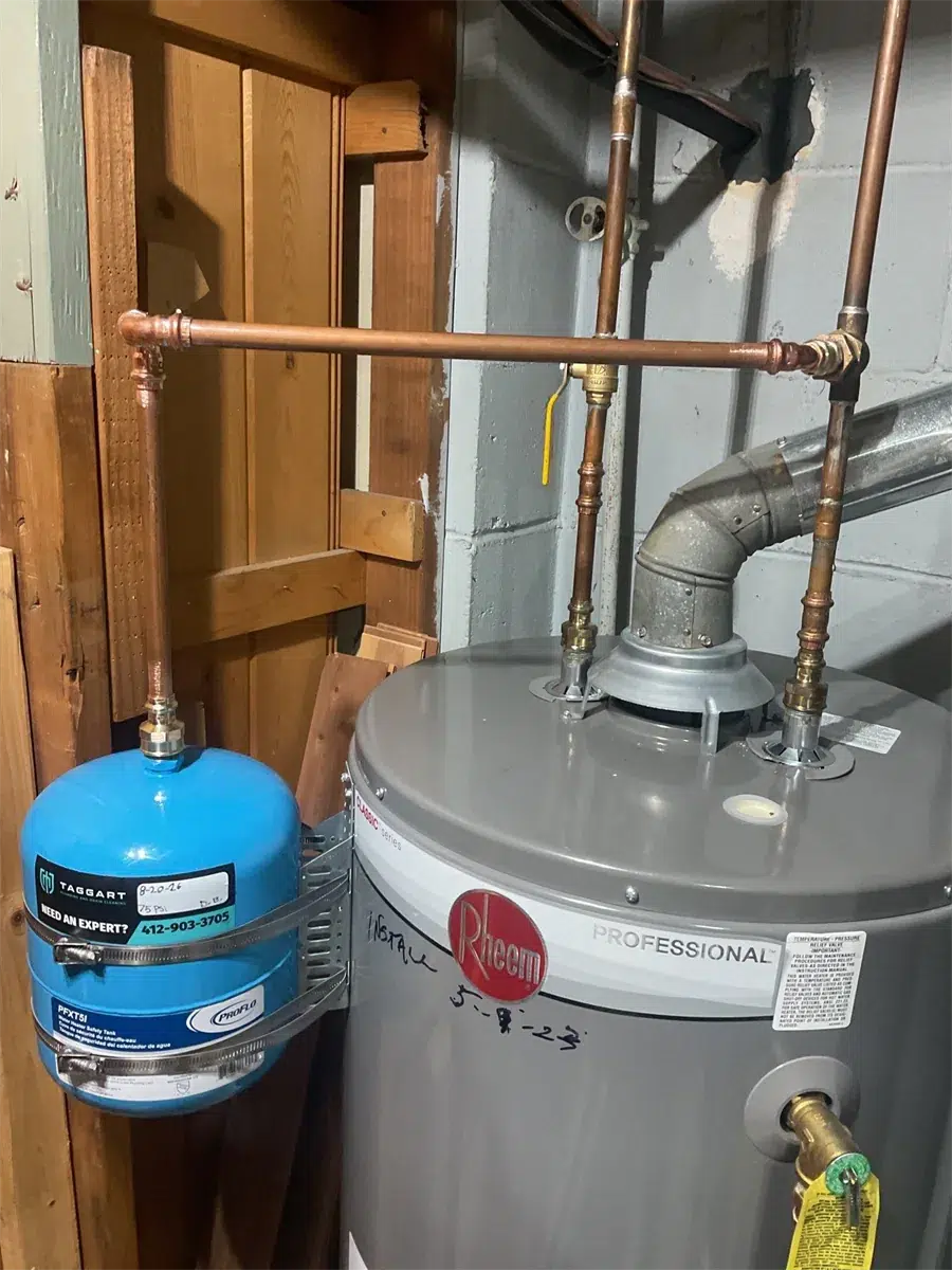Rheem water heater with blue expansion tank and copper lines in Pittsburgh, PA