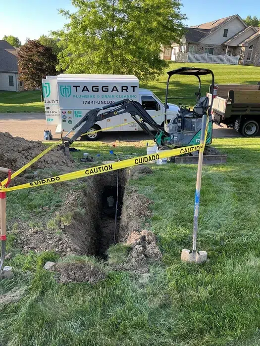 Taggart Plumbing truck beside an open excavation for a water line replacement in Cranberry Township, PA