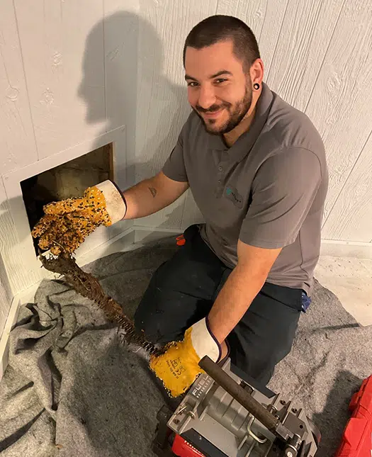 Taggart plumbing using drain cleaning machine with drop cloth to protect floor