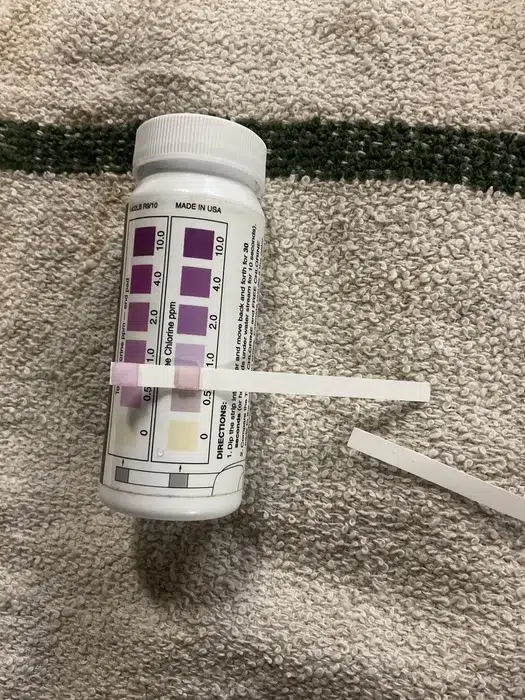 Home water quality test strip showing mineral results during a residential water testing visit in Pittsburgh, PA