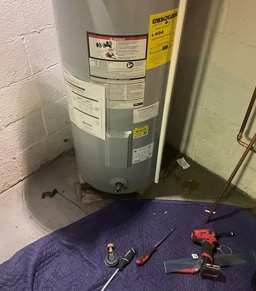 water heater maintenance in Freedom PA with drop cloth to protect floors